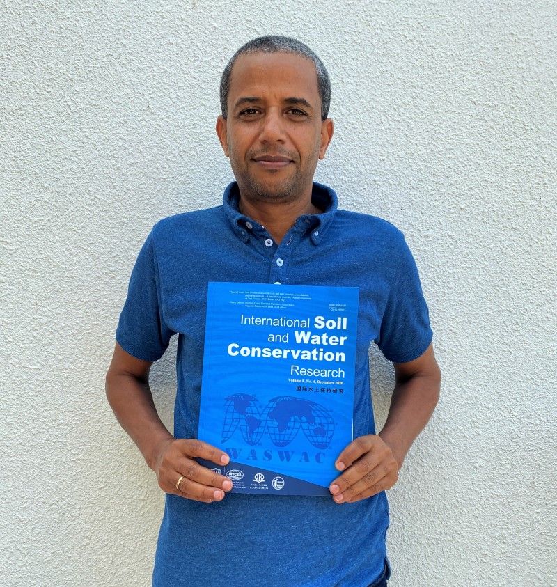 Prof. Haregeweyn holding the Special Issue he contributed as a Guest Editor.